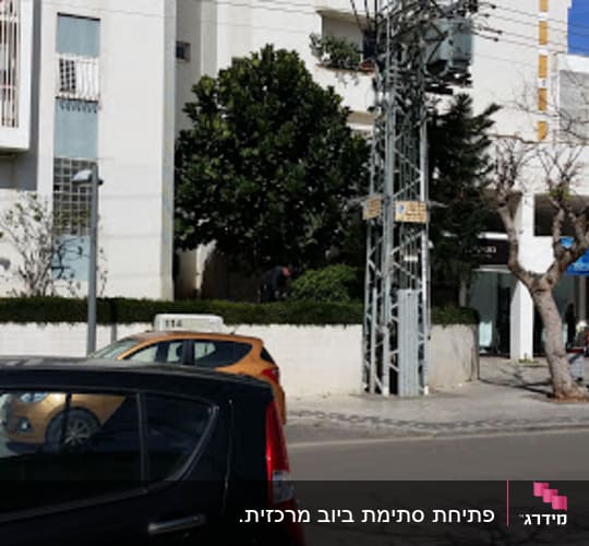 Street scene with cars and a building, no visible plumber elements.